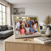 Digital photo frame displaying a family at a barbecue in a living room setting.